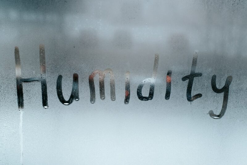 Word Humidity written on misted wet window glass. Concept weather, climate, meteorology